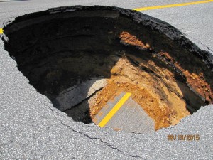 Courtesy photo by N.H. Department of Transportation The stretch of I-93 where a sinkhole opened up Aug. 19 was built atop an older road, portions of which can be seen here. Below that is a century-old water line made of brick which failed, leading to the sinkhole. -