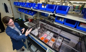 Lab technician Laurie Tomaselli shows the dye unit that helps to identifiy pathogens in slides of tissue at the New Hampshire Veterinary Diagnostic Lab on the campus of UNH Wednesday.  (GEOFF FORESTER / Monitor staff) - GEOFF FORESTER | Concord Monitor