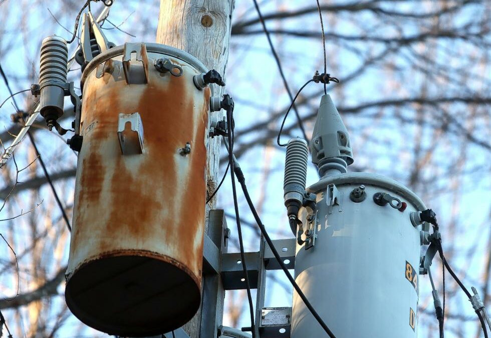 The cone-shaped object on top of the right transformer on Route 3 in Boscawen near the border with Concord makes it so that squirrels can’t climb up them and cause an outage.  (GEOFF FORESTER / Monitor staff)