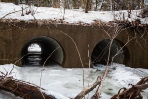 Water flows through a large two-pipe culvert underneath Everett Dam Road in Dunbarton on Saturday, Feb. 20, 2016.  A new processing tool is designed to help communities decide which culverts need replacing as flooding becomes more common. (ELIZABETH FRANTZ / Monitor staff) - ELIZABETH FRANTZ | Concord Monitor