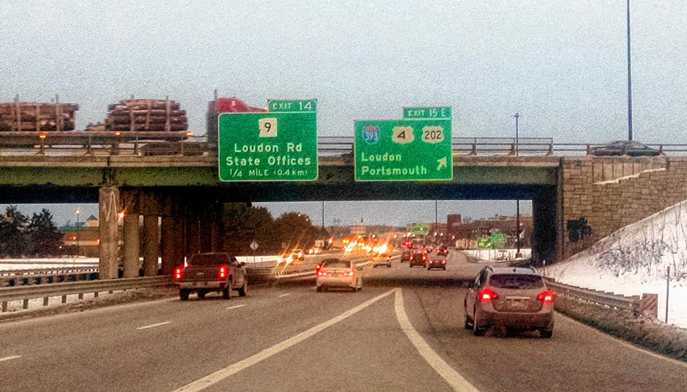 These two signs on I-93 at Exit 15 in Concord have different patterns of reflective materials, and were placed to study which works better. The sign at left has one coating for the background and a different coating for the letters. The sign at right has the same coating on both background and letters, which makes the words harder to distinguish at night. The left sign is now the state standard. (  DAVID BROOKS / Monitor staff)