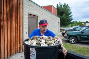 Ron Rayner secures a 20-gallon bin full of oyster shells outside Newicks Lobster House in Concord on June 22, 2016, before visiting three other restaurants. Rayner said the bin typically weighs about 100 pounds. (ELIZABETH FRANTZ / Monitor staff)
