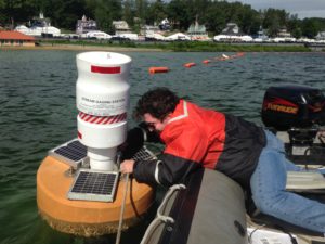 USGS scientist Joseph Levitt secured a buoy equipped to monitor water quality at Weirs Beach on Lake Winnipesaukee in June. Sanborn Ward / U.S. Geological Survey