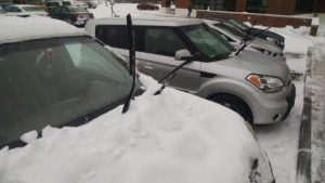 snow-covered car with windshield wipers up
