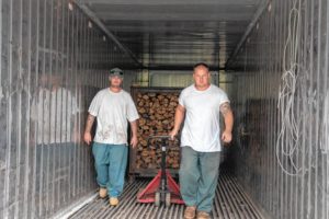Inmates Dylan Greene (left) and John Hammond load the kiln to dry firewood and kill invasive bugs while working with the Department of Corrections Transitional Work Center in Concord on Wednesday, July 25, 2018. The wood will be distributed to state parks and sold as firewood for campers. Maddie Vanderpool / Monitor staff