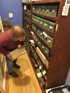 Barbara Tortorell, vice president of the Milford Historical Society, examines the collection of over 43,000 photo negatives donated by N.H. aviation pioneer Bernice Blake, N.H.'s first licensed female pilot.
