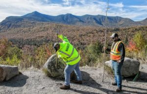 Shawn Woods (left), and John Narrow who both work out of the Lincoln Deptartment of Transportation work on putting in the whips in the parking lot of overlook on the Kancamagus highway just out of Lincoln on Tuesday, October 8, 2019.