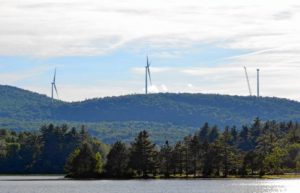 View from the Antrim Town Beach shows turbines for the Antrim Wind project going up in July, 2019. Photo: Monadnock Ledger