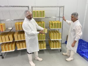 ounders Adam Hamilton, left and Josh Velaquez show some package of their cashew chees spread in the cooler at the Nuttin Ordinary facility in Peterborough