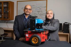 Sajay Arthanat, professor of occupational therapy (left) and Momotaz Begum, assistant professor of computer science (right) co-principal investigators with prototype of robot for aging patients with Alzheimer’s Disease and related dementia. Photo credit: UNH