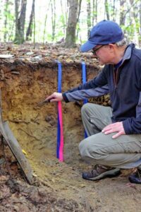 Soil scientist Adam Doiron analyzes a pit dug as part of a soil judging contest at Kingman Research Farm in Madbury. Oct. 6, 2022 Nicholas Gosling—Courtesy