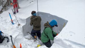 Mount Washington Avalanche Center forecasters are shown digging a deep snow pit to look for weak layers deeper in the snowpack as part of avalanche assessment during the winter of 2021-22. USDA Forest Service