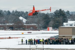 Rotor’s R220Y, an uncrewed R&D aircraft based on the Robinson R22 2-seat helicopter, takes flight without anyone onboard for the first public test flight at the Nashua Airport while guests look on.